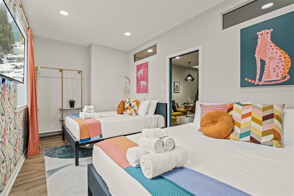 Wake up to cheerful colors and soft light in this playful bedroom designed for both comfort and joy.