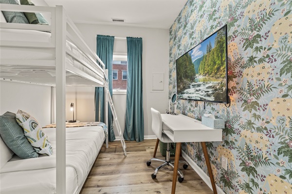 Perfect for families or friends — this cheerful bunk room adds fun and comfort with plenty of cozy touches.