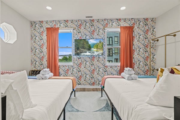 Vibrant décor and plush bedding make this room as stylish as it is restful — every detail feels curated.