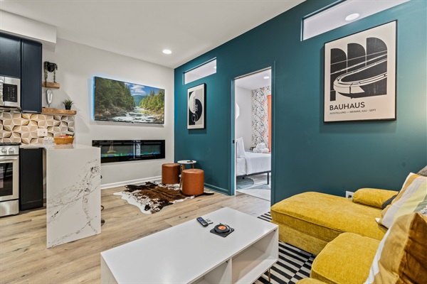 Relax in style with bold design, cozy textures, and seamless flow from living to kitchen to rest.