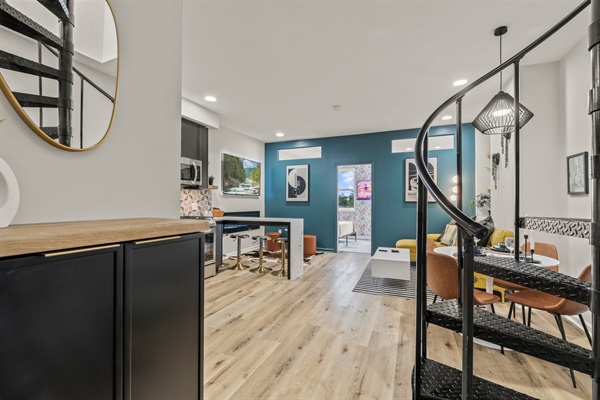 Sleek lines and bold color flow through this open-concept space — where design and comfort meet.