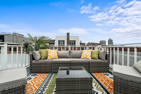 Relax on the private roof deck with plush seating, vibrant décor, and skyline views — your own city oasis.