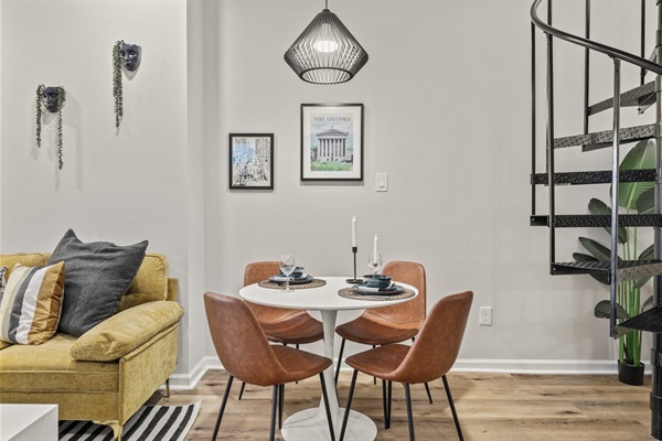 Gather for breakfast or dinner in this stylish dining area framed by art and modern lighting.