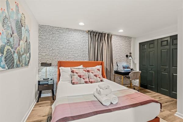 Vibrant yet tranquil—this beautifully designed bedroom pairs modern art with all the comforts of home.