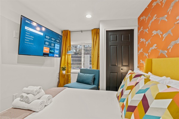 Stream your favorite shows from bed—this vibrant retreat pairs playful design with plush comfort.