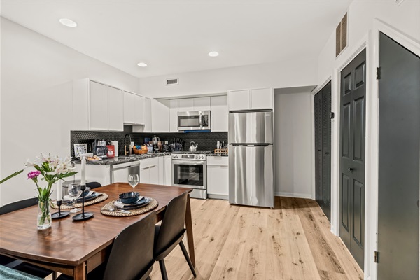 Enjoy meals together in this stylish kitchen—fully stocked and designed for both easy mornings and relaxed dinners.