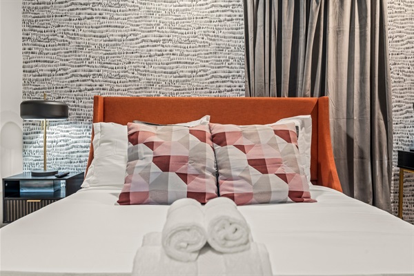 Cozy meets chic—this designer bedroom blends bold color, texture, and comfort for the perfect night’s sleep.