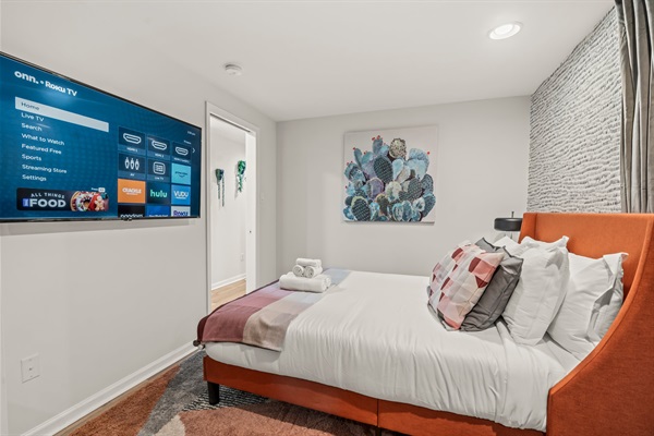 Wake up inspired—this bright, stylish bedroom offers both restful sleep and a dedicated workspace.