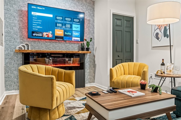 A designer’s dream — vibrant seating and sleek textures make this living space both modern and inviting.