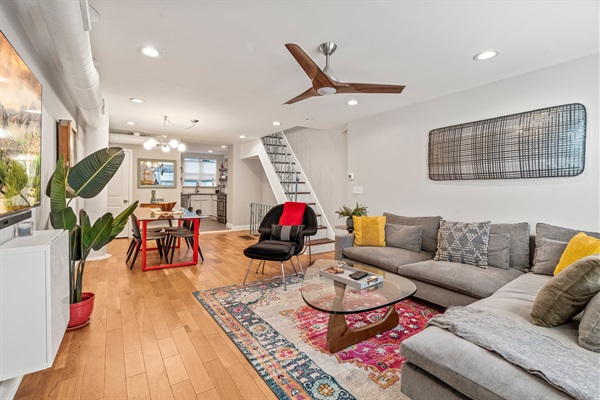 Bright, open living area with modern décor and warm textures—perfect for relaxing or hosting during your stay.