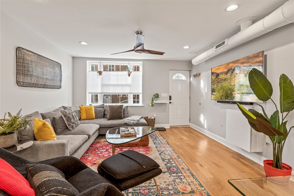 A stylish lounge with curated art, plush seating, and streaming-ready TV—your comfortable retreat in the city.