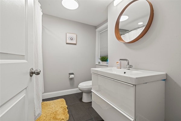 Your Modern bathroom with a floating vanity, round mirror, and fresh, spa-inspired details.
