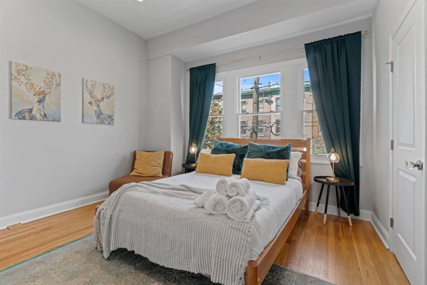 You will appreciate the cozy and well-appointed bedroom, complete with soft linens and plush pillows. The natural light and tasteful decor create a serene and restful retreat for a perfect night’s sleep.