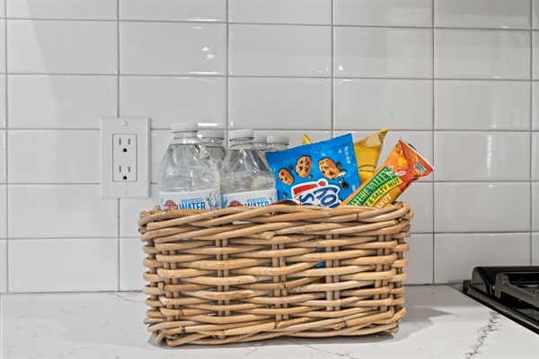 Enjoy the complimentary snack basket, thoughtfully provided to keep you refreshed. It includes a variety of treats and bottled water, perfect for a quick bite or to pack for your adventures.