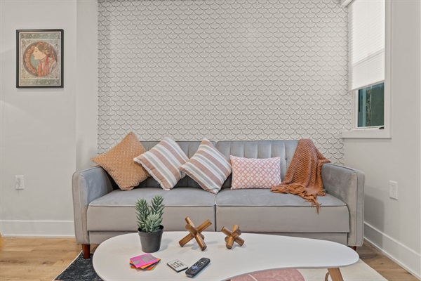 Soft textures, warm tones, and curated art make this stylish living area your go-to unwind spot.