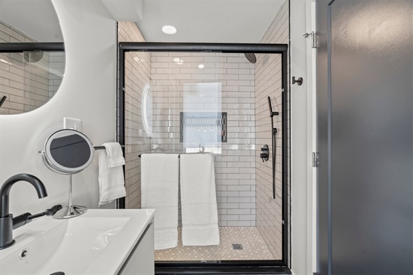 Walk-in shower with subway tile and rain head—fresh, modern, and designed for relaxation.